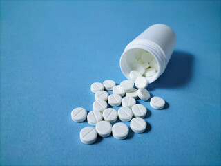 white tablets on blue paper background