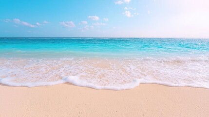 Fototapeta premium Tropical beach waves gently lapping on white sand under a bright blue sky. Use Travel brochures, vacation websites