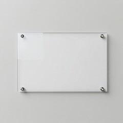 Clear rectangular acrylic sign mounted on a gray wall with four metallic standoffs.