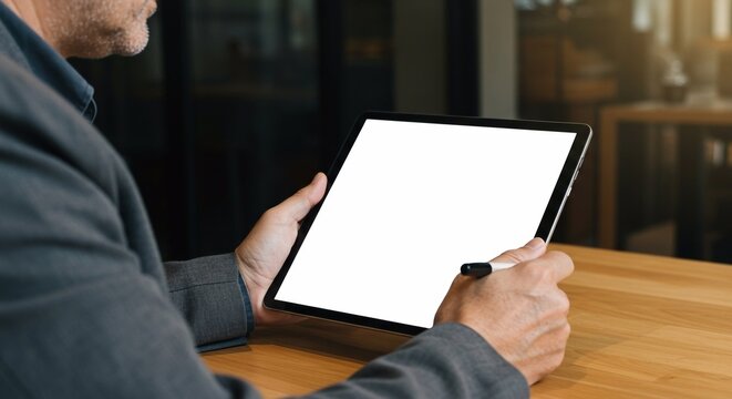 Businessman Using tablet with blank screen for design mockup device Tablet with blank screen for design mockup

