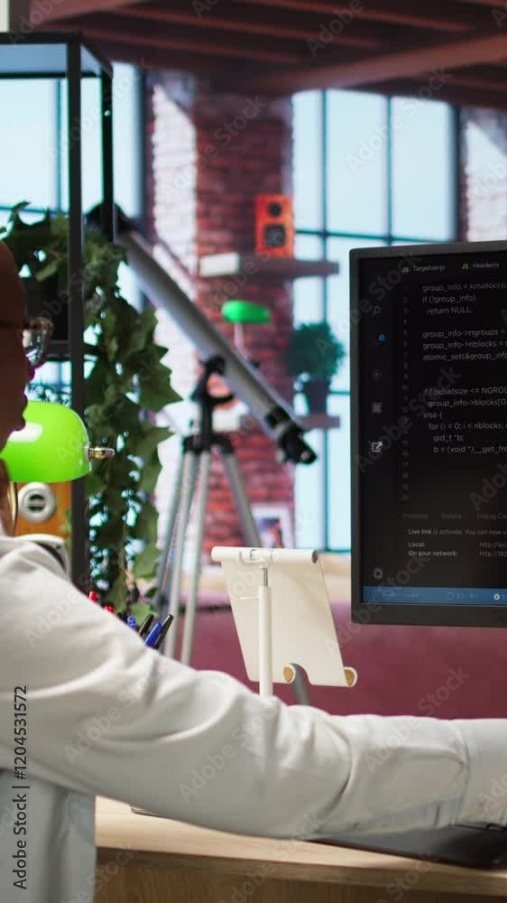 Poster vertical video software developer wearing headphones using computer at home for artificial intellige