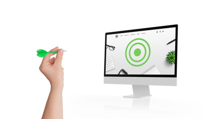 Hand holding a dart aiming at a monitor displaying a target on a conceptual web page, symbolizing...