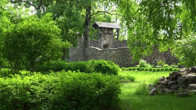 A zoomed-in view of the stone walls of Dobele Castle ruins (Latvia, Europe) in summer, showcasing the monumental details of this medieval building and historical architecture in a video scene.