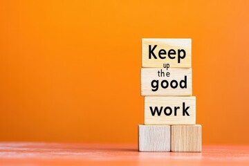 Wooden cubes showing keep up the good work encouraging message