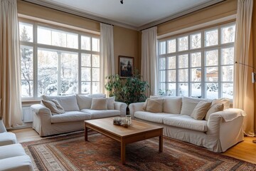 Fototapeta premium Elegant living room overlooking snowy winter landscape through large windows