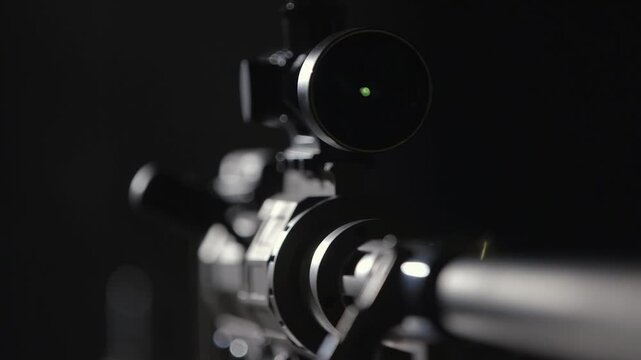 Modern assault rifle on black background with reflection. Sniper rifle with optical sight, black background, close up, studio shot with shallow depth of field. Detailed review of sniper assault rifle.