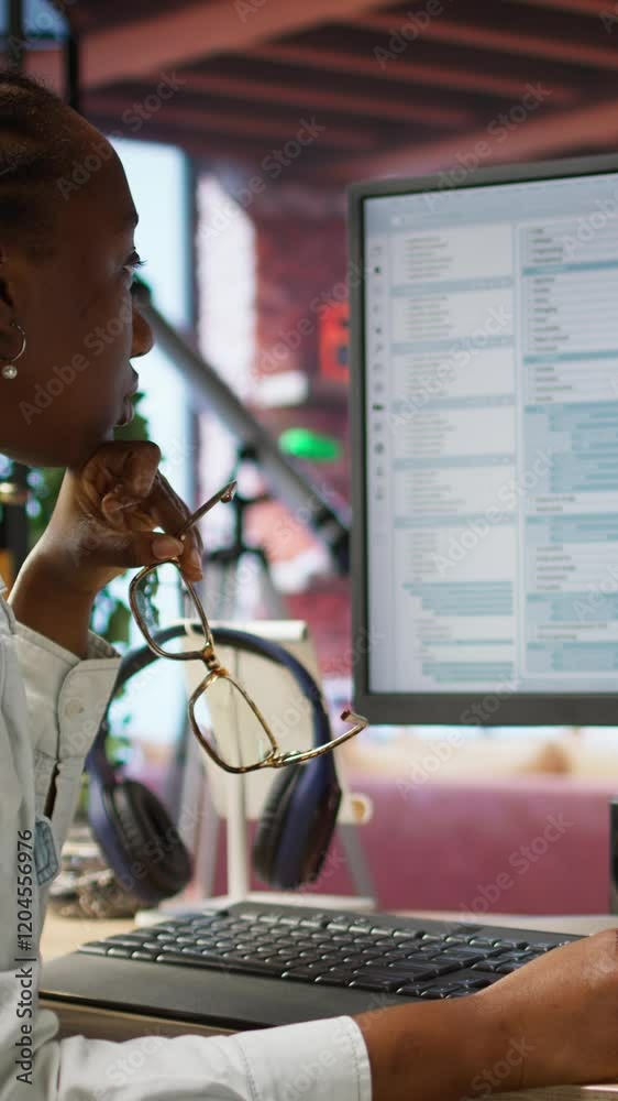 Fototapete Vertical video Irked software developer frustrated while coding, struggling to implement algorithms. Unhappy IT expert annoyed while working with code editor, unable to optimize performance, camera A