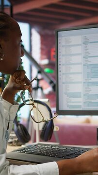 Vertical video Irked software developer frustrated while coding, struggling to implement algorithms. Unhappy IT expert annoyed while working with code editor, unable to optimize performance, camera A