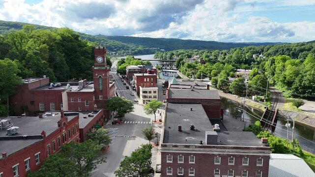 Small little town in southern Vermont with quaint downtown area with brick buildings. Drone video of Bellows Falls, Vermont on a summer day.