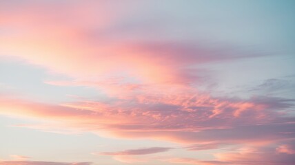 Fototapeta premium A serene sky showcasing pastel hues of pink and blue at sunset, creating a calm and dreamy mood perfect for relaxation.