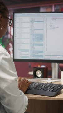 Vertical video Coder at workstation programming on PC, writing lines of code, using development tools, feeling stressed. Woman in home office having deadline, stressed to finish debugging software