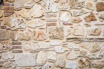 Rustic stone and brick wall with weathered texture