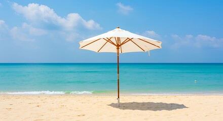 Fototapeta premium Serene white beach umbrella standing alone on sandy shore, concept for summer vacation, relaxation and travel brochure