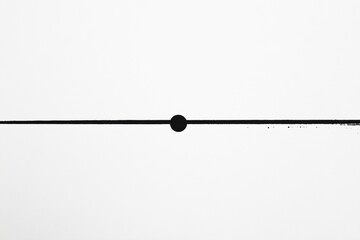 Horizontal black line with central dot displayed on white background creating minimalist art effect in contemporary style. Generative AI