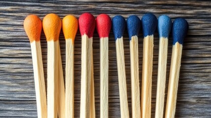 Colorful matches arranged on a wooden surface.