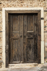 Weathered wooden door in rustic stone wall