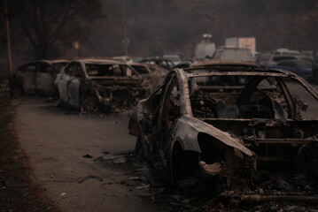 Cars destroyed in the palisades fire blocking the road