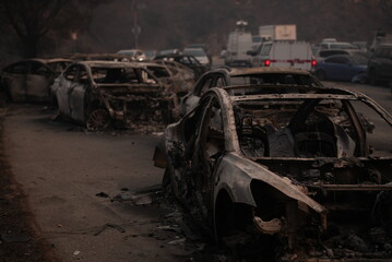 Cars destroyed in the palisades fire blocking the road