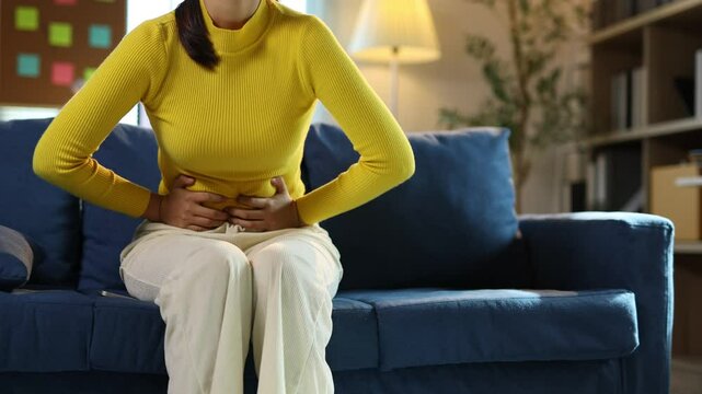 Young woman suffering from stomach ache.