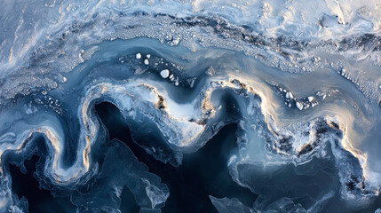 Fototapeta premium Abstract aerial view of icy landscape showcasing intricate patterns of snow, frozen water, and dynamic textures in shades of blue and white, capturing winter's beauty.