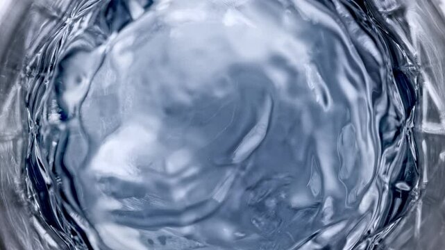 Super Slow Motion Detail Shot of Waving Vodka in Glass at 1000 fps.