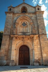 Fototapeta premium Medieval Stone Church Facade with Chiaroscuro Lighting and Intricate Architecture in Palagianello Italy