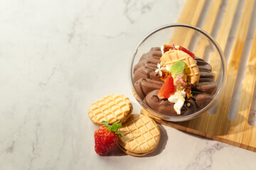 A dessert with strawberries and whipped cream in a glass bowl