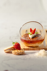 A dessert with strawberries and whipped cream in a glass bowl