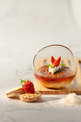 A dessert with strawberries and whipped cream in a glass bowl