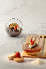 A dessert with strawberries and whipped cream in a glass bowl