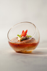 A dessert with strawberries and whipped cream in a glass bowl