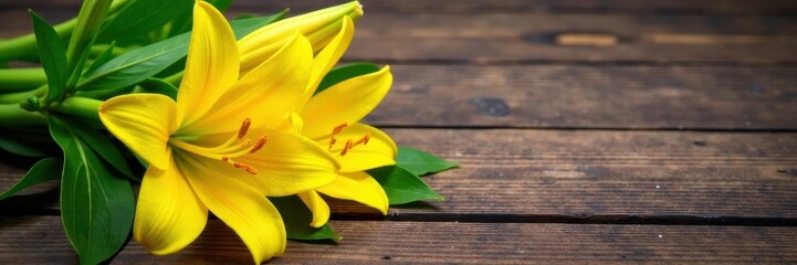 Obraz premium Yellow lily stems with green leaves on a wooden table, flowers arrangement, leaves, wood