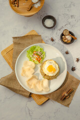 A plate of food with rice, egg, and vegetables