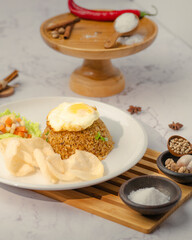 A plate of food with rice, egg, and vegetables
