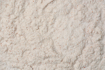 close-up of finely ground coconut flakes to extract coconut milk in full frame food background, creamy flavorful liquid widely used in cooking and baking