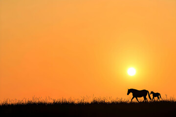 Naklejka premium Silhouettes of Horses at Sunset on a Tranquil Pastoral Landscape