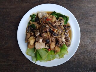 stir fry mushrooms with green mustard and egg as garnish 