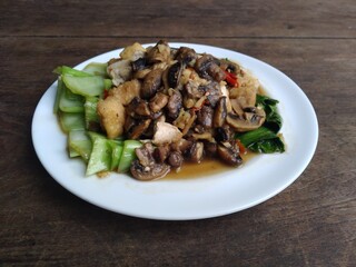stir fry mushrooms with green mustard and egg as garnish 