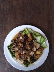 stir fry mushrooms with green mustard and egg as garnish 