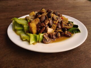 stir fry mushrooms with green mustard and egg as garnish 