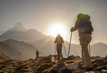 Group of tourist walking to Mardi Himal base camp with beautiful view of Mt.Machapuchare at dawn....