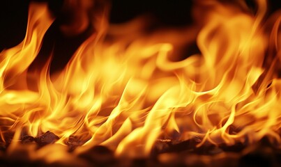 Fototapeta premium Close-up of intense orange flames burning against a dark background, ideal for fire safety or heat concepts