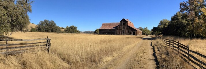 An old barn in the distance, surrounded by trees and tall grasses on both sides of an open field with a dirt road leading up to it. The sky is clear and blue. A wooden fence surrounds the area.