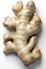 A piece of ginger root with a few bumps and ridges. It is a root vegetable that is often used in cooking
