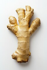 A piece of ginger root with a few bumps and ridges. It is a root vegetable that is often used in cooking