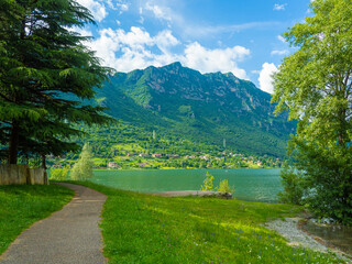 Serene Lake Idro Surrounded by Majestic Mountains and Cloudy sky, Italy, Crone