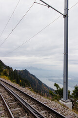 Mountain railway tracks overlooking a lake