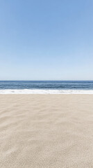 Fototapeta premium Peaceful sandy beach under a clear blue sky near the calm ocean waves