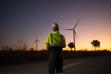 Engineers are working survey and checking wind turbines on field. Green ecological power energy generation wind sustainable energy concept. © Nabodin
