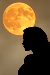 Woman's silhouette against a large, orange moon.